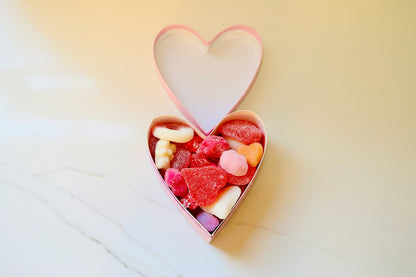 Heart-shaped box filled with colorful gummy candies